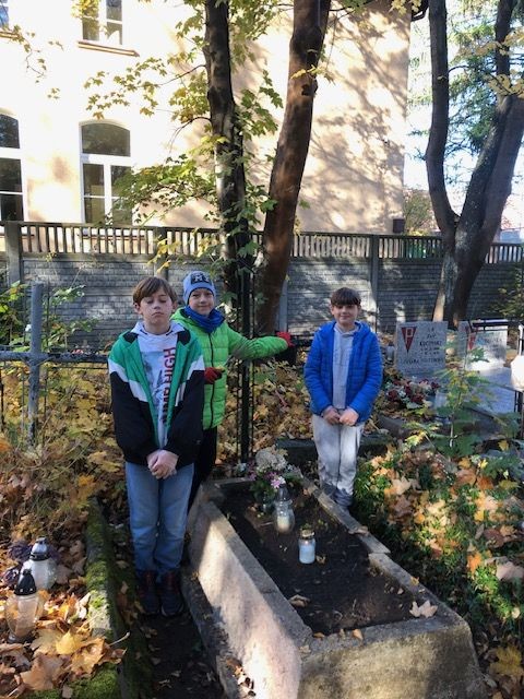 uczniowie przy nagrobku na starym cmentarzu w Wejherowie